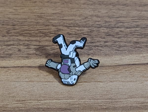 Astronaut Hard Enamel Pin. This pin is out of this world with a space design. White grey and purple colours on this guy.