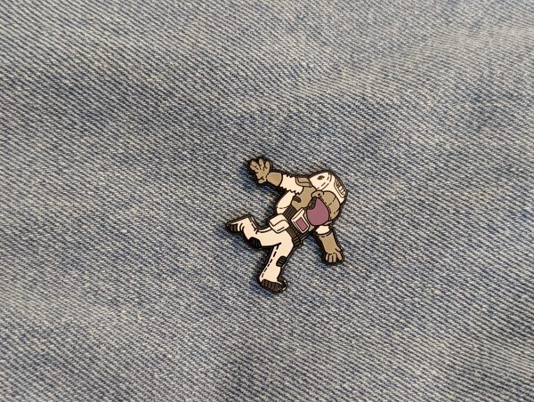 Astronaut Hard Enamel Pin. This pin floats on denim. White grey and purple colours on this guy.