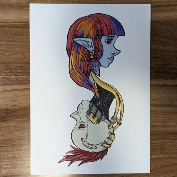 Elf girl and Android girl side profile portraits. Entwined and flowing together. Framed sitting on a table top. Elf is blue with large ears, multi-coloured hair. Android is beige with golden plates and parts connected. She has a red mohawk! Print sitting on table.